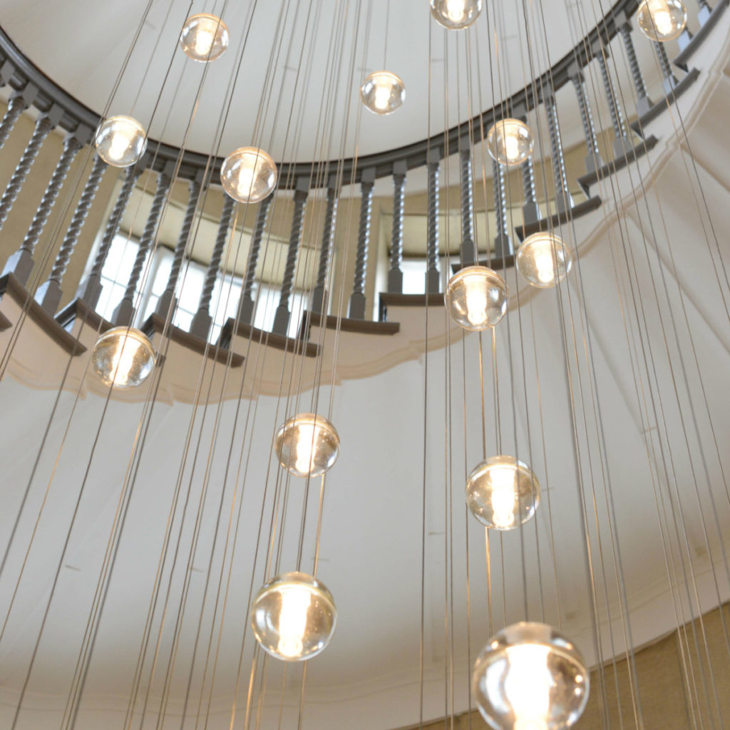 14 Series Pendant. The iconic light is  shown here hanging in the Brewer Staircase at the Heal's store on Tottenham Court Road