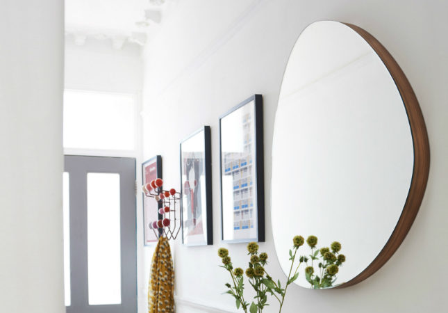 Orta Round Mirror on a hallway wall