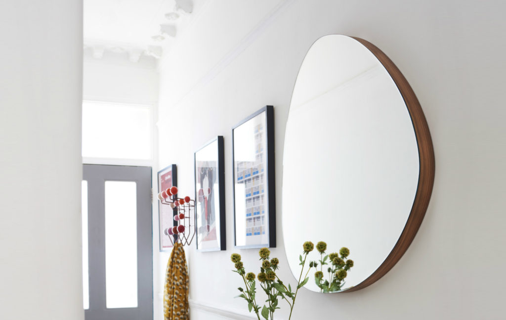 Orta Round Mirror on a hallway wall