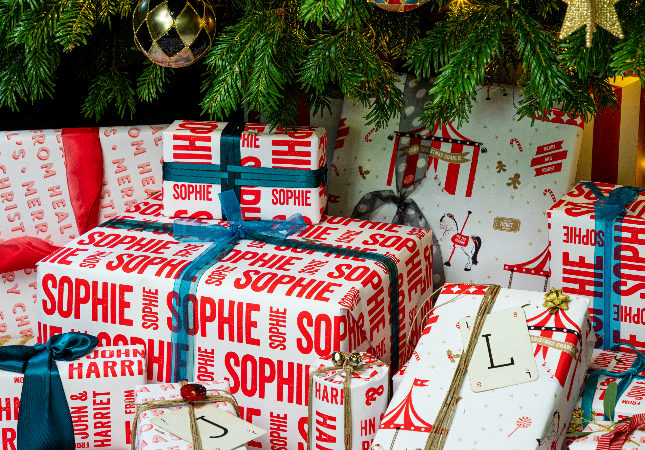 Presents under the Christmas tree with personalised paper