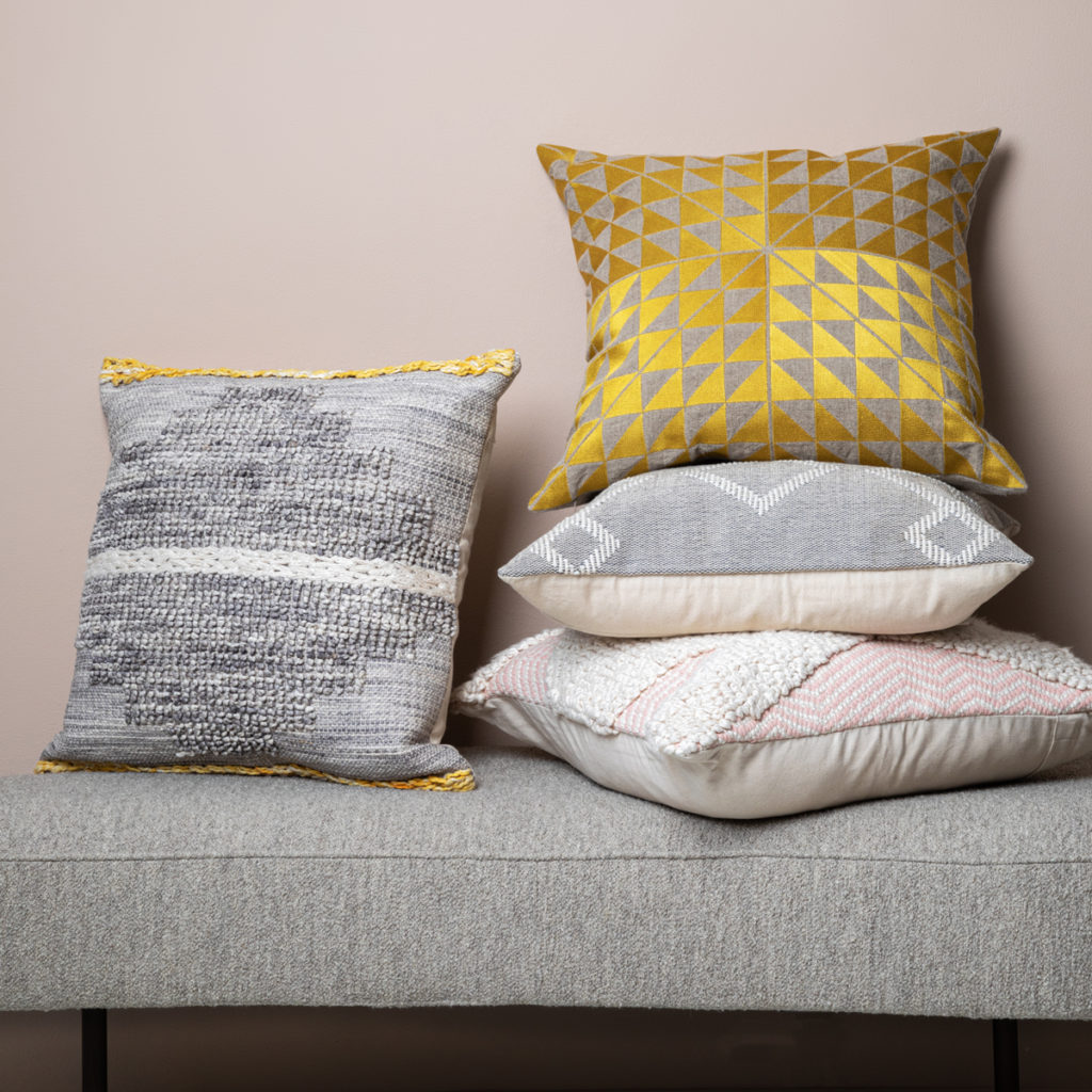 Use cushions to enliven a rental property sofa