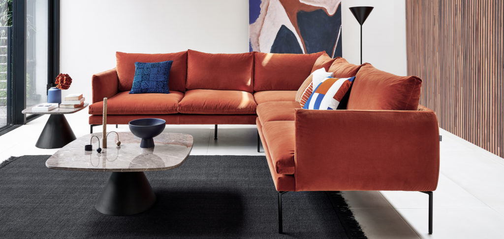 Plain Rug with rust red sofa