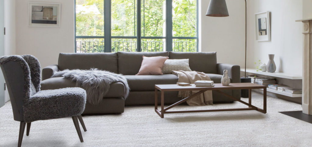 Grey sofa with a neutral carpet