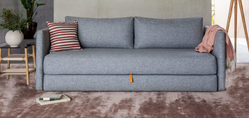 Grey sofa with a pink carpet