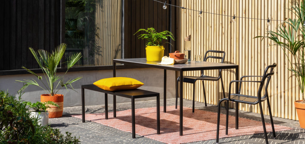 Modern outdoor dining space in a corner