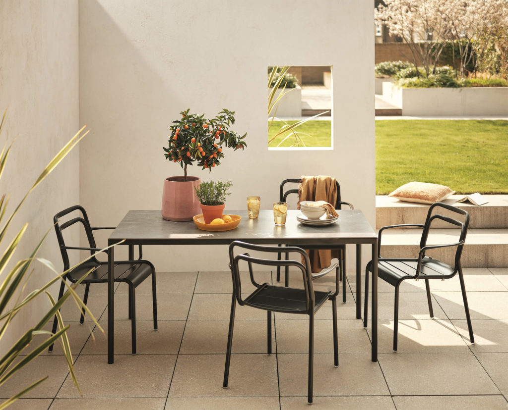 Outdoor dining set up, featuring a dining table and four chairs.