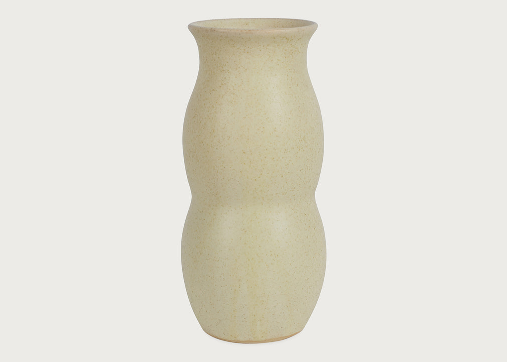 A speckled ceramic vase with a textured cream-beige finish, featuring a unique double-bulbous silhouette, set against a solid off-white background.