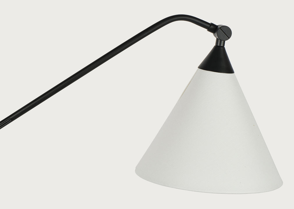 A modern adjustable desk lamp featuring a matte black metal arm and a tapered white metal shade, shown against a solid off-white background.
