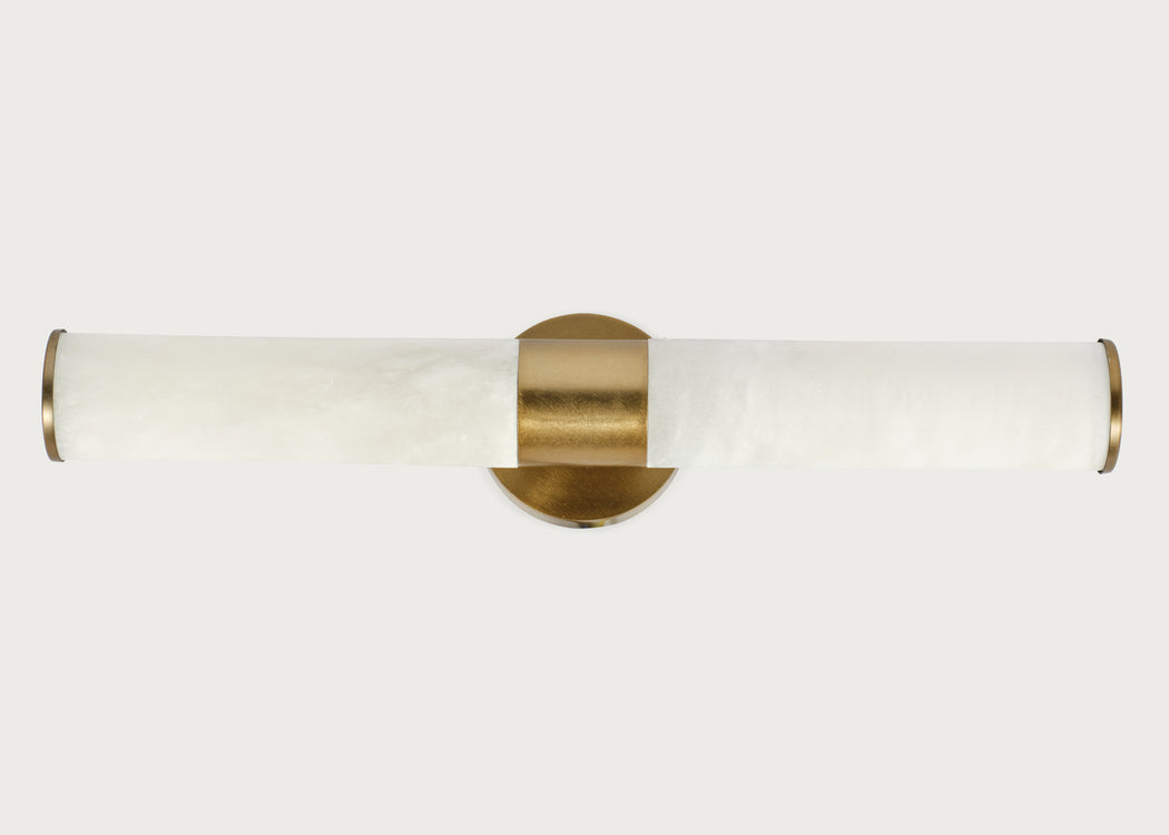 A modern wall-mounted light fixture with a cylindrical white marble shade and brushed brass hardware, shown against a light gray background.