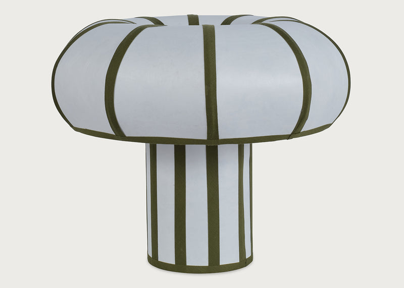 A mushroom-shaped table lamp with a white fabric-covered top and base, accented by olive green vertical stripes, shown against a light gray background.