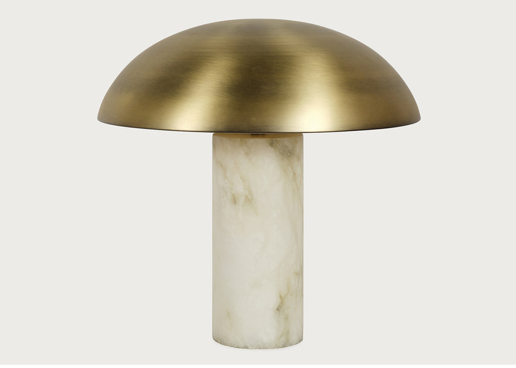 A mushroom-shaped table lamp with a brushed brass dome-shaped shade and a cylindrical alabaster base, shown against a light gray background.