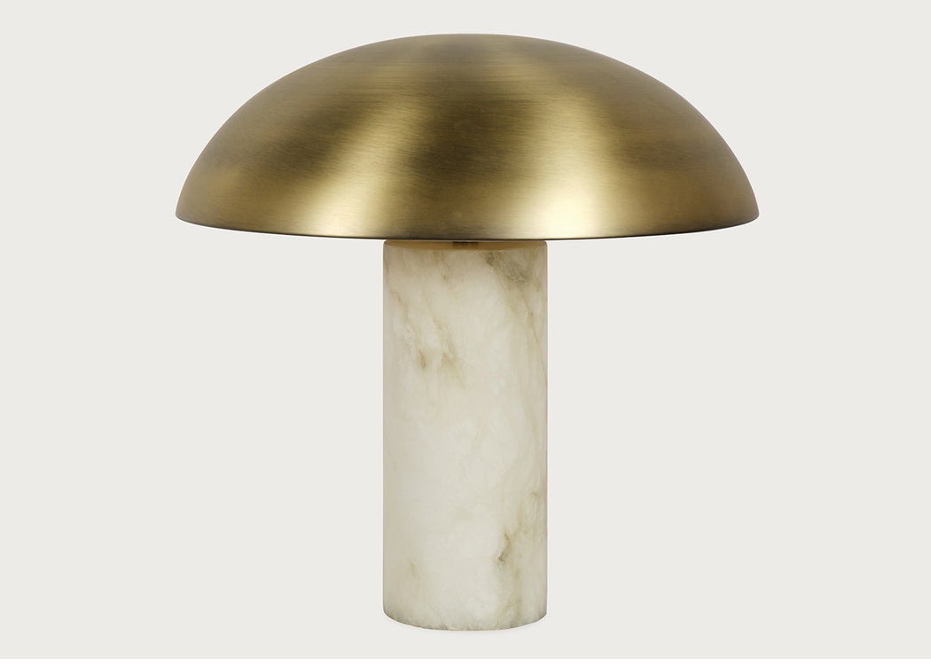 A mushroom-shaped table lamp with a brushed brass dome-shaped shade and a cylindrical alabaster base, shown against a light gray background.
