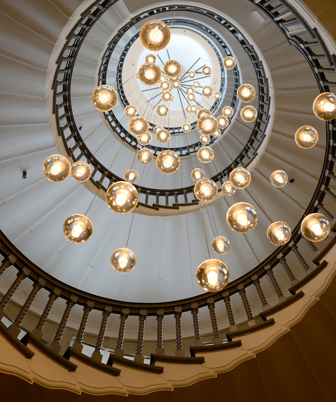 Cecil Brewer spiral staircase with Bocci chandelier at Heal's Tottenham Court Road
