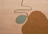Abstract area rug with a warm beige base, a large organic brown shape, a muted sage green oval, and a thin black wavy line detail.