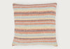 A square throw pillow with a woven horizontal striped pattern in orange, brown, beige, and light blue on a light gray background.